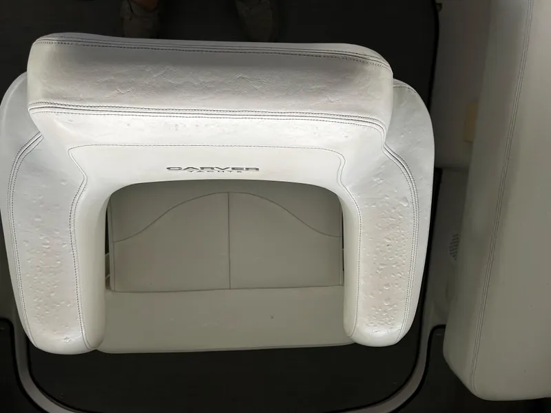 Slide: The Image of White leather seat on a 2000 Carver 396 boat, featuring elegant stitching. - 36