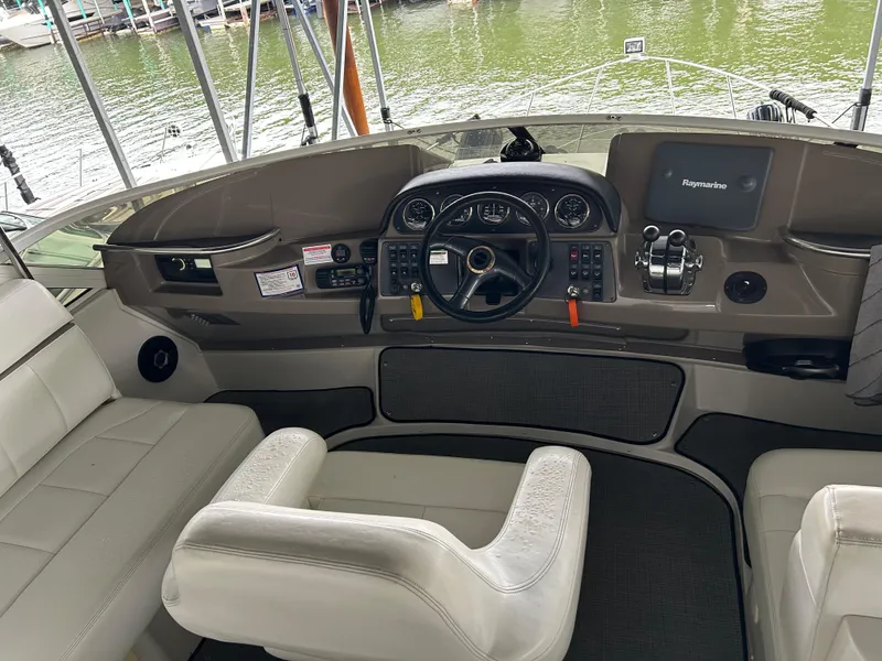 Slide: The Image of Interior of a 2000 Carver 396 yacht cockpit with steering wheel and navigation equipment. - 38