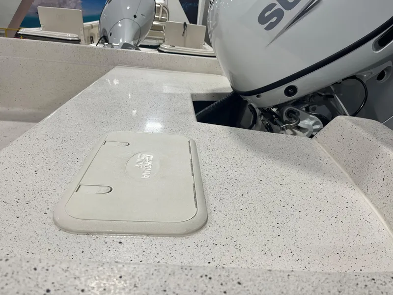 Slide: The Image of 2024 Carolina Skiff e21 DLX boat deck with Suzuki outboard motor. - 10