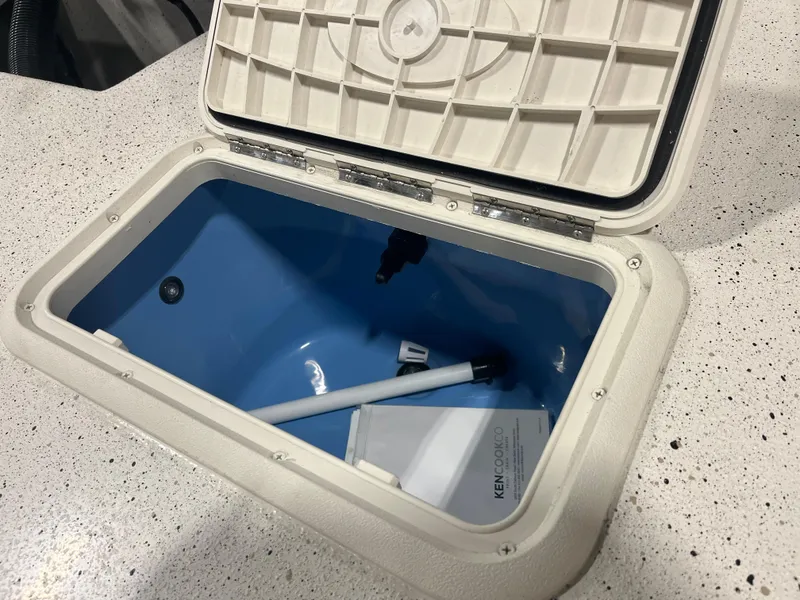 Slide: The Image of 2024 Carolina Skiff e21 DLX storage compartment with open lid. - 11