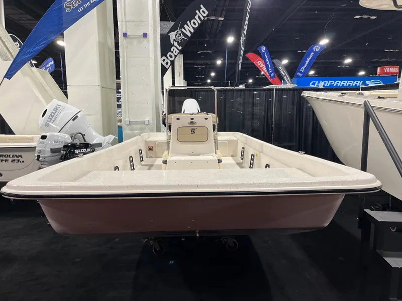 Slide: The Image of 2024 Carolina Skiff e21 DLX boat on display at a boat show. - 12