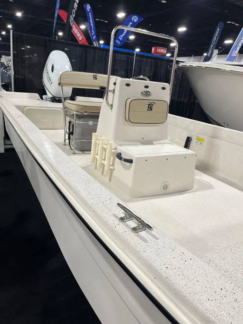 Slide: The Image of 2024 Carolina Skiff e21 DLX boat on display at a boat show. - 13