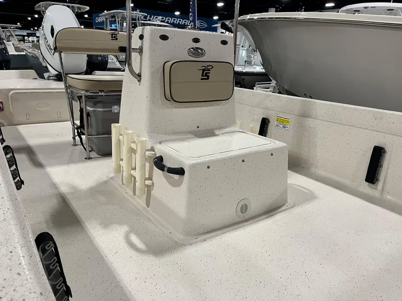 Slide: The Image of 2024 Carolina Skiff e21 DLX boat interior with center console and rod holders. - 2