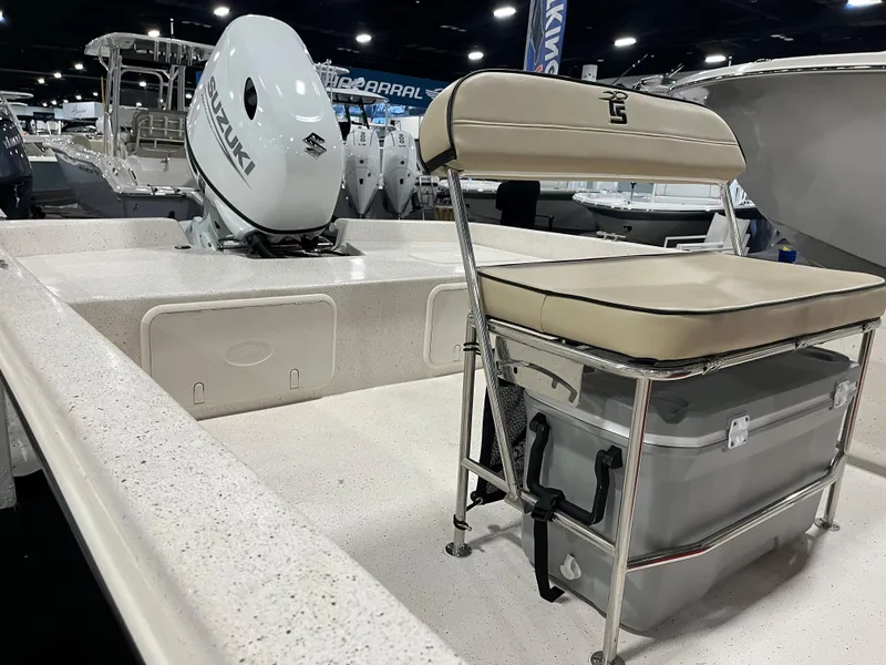 Slide: The Image of 2024 Carolina Skiff e21 DLX boat interior with Suzuki outboard motor. - 4