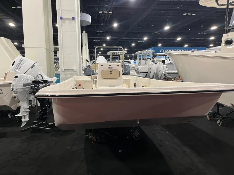 Slide: The Image of 2024 Carolina Skiff e21 DLX boat on display at an indoor boat show. - 8