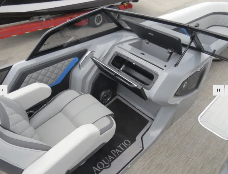 Slide: The Image of 2023 Godfrey AquaPatio 255 DFLW boat interior with helm and seating. - 10
