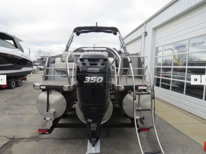 Slide: The Image of 2023 Godfrey AquaPatio 255 DFLW pontoon boat with a 350 Verado engine, rear view. - 6