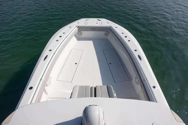 Slide: The Image of 2023 SeaHunter 46 CTS boat deck, spacious and sleek design on calm water. - 18