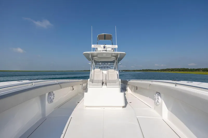 Slide: The Image of 2023 SeaHunter 46 CTS boat on open water under clear blue sky. - 19