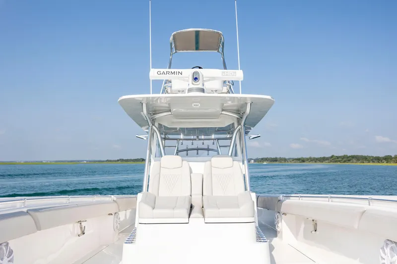 Slide: The Image of 2023 SeaHunter 46 CTS boat on calm water, featuring a sleek design and advanced navigation equipment. - 20