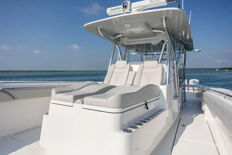 Slide: The Image of 2023 SeaHunter 46 CTS boat with luxurious seating and sleek design on open water. - 21