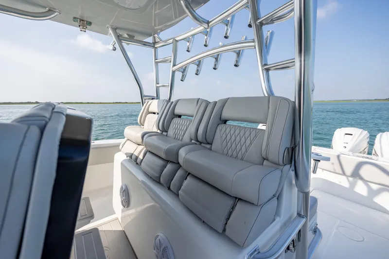 Slide: The Image of 2023 SeaHunter 46 CTS boat interior with luxurious seating and rod holders, on a sunny day. - 24
