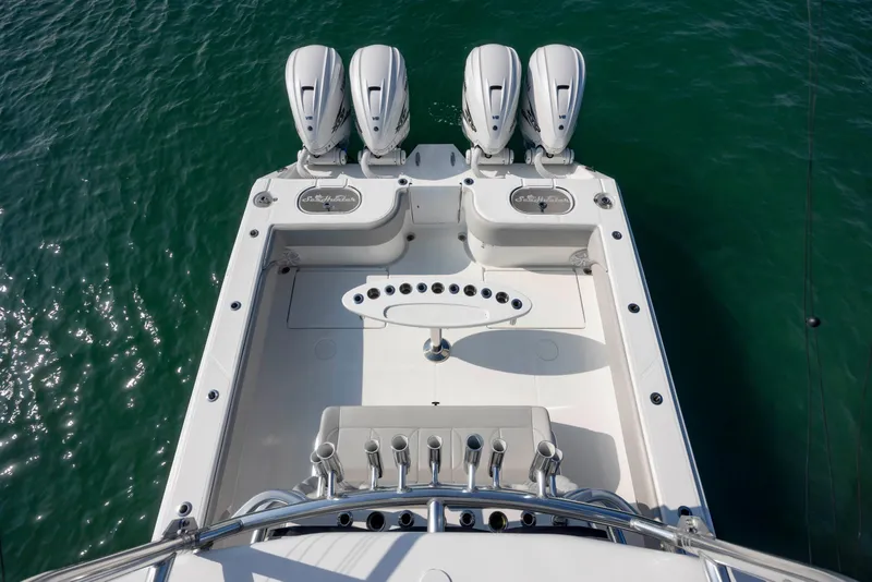 Slide: The Image of 2023 SeaHunter 46 CTS boat with four powerful outboard engines on turquoise water. - 25