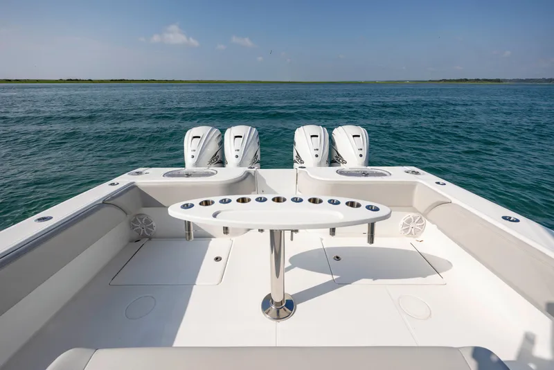 Slide: The Image of 2023 SeaHunter 46 CTS boat with triple engines, spacious deck, and ocean view. - 26