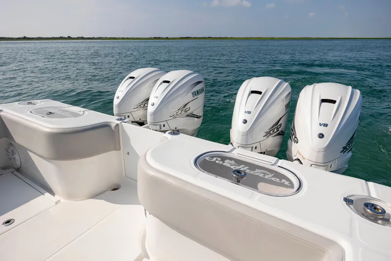 Slide: The Image of 2023 SeaHunter 46 CTS boat with four Yamaha V8 engines on open water. - 28