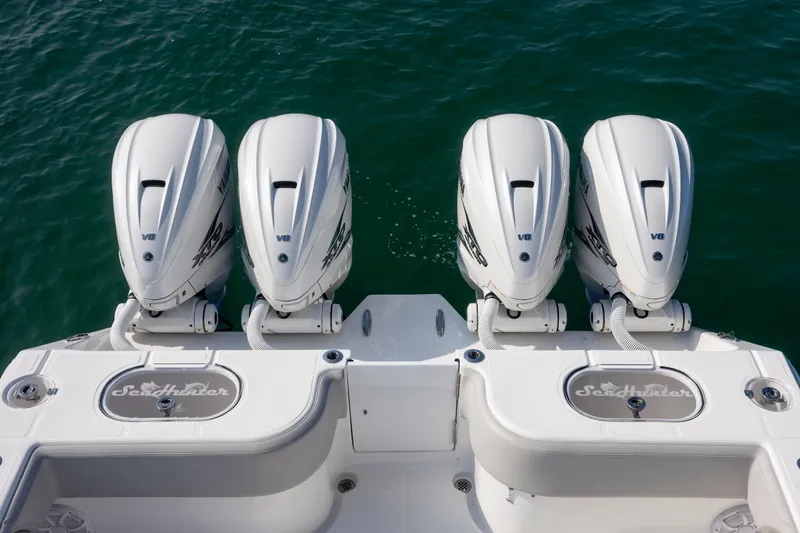 Slide: The Image of Four powerful outboard engines on a 2023 SeaHunter 46 CTS boat. - 29