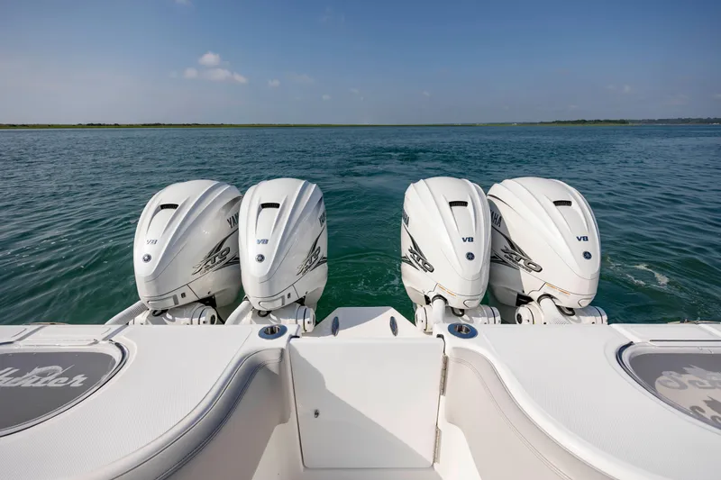 Slide: The Image of 2023 SeaHunter 46 CTS boat with four powerful V8 engines on open water. - 30