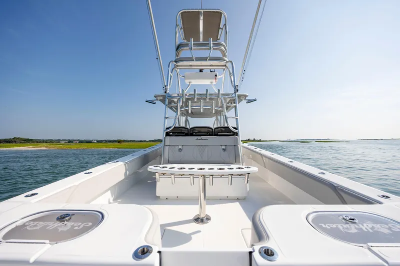 Slide: The Image of 2023 SeaHunter 46 CTS boat on water, featuring spacious deck and seating. - 31
