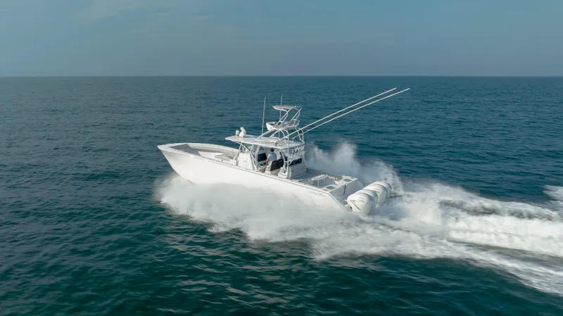 Slide: The Image of 2023 SeaHunter 46 CTS boat cruising swiftly on open ocean waters. - 41