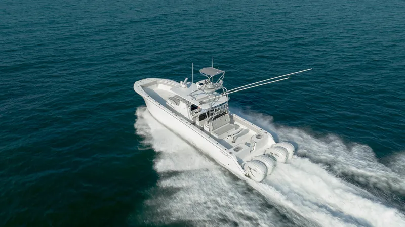 Slide: The Image of 2023 SeaHunter 46 CTS boat cruising on open water, showcasing powerful engines and sleek design. - 42