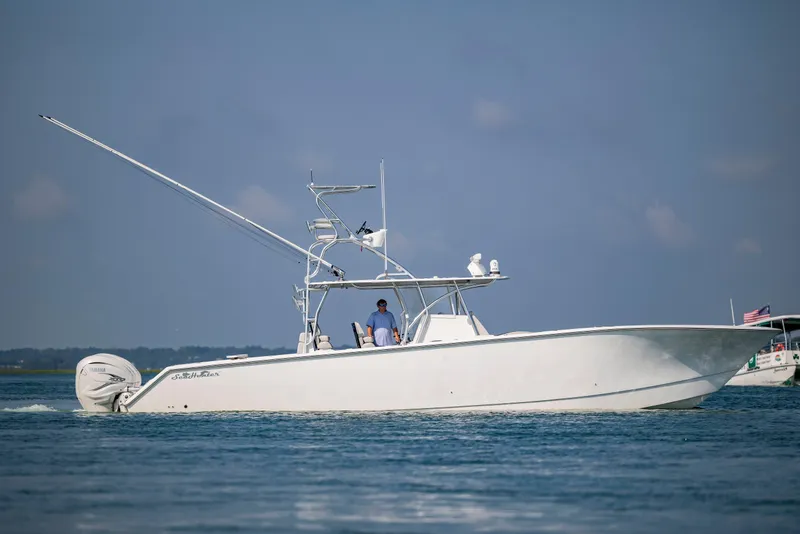 Slide: The Image of 2023 SeaHunter 46 CTS boat cruising on calm blue waters under clear skies. - 43