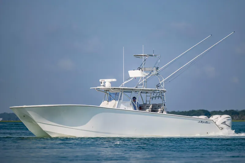 Slide: The Image of 2023 SeaHunter 46 CTS boat cruising on calm blue waters. - 44