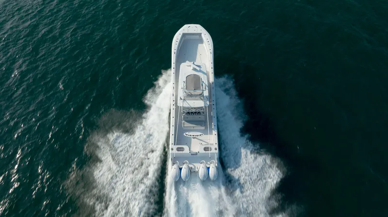 Slide: The Image of 2023 SeaHunter 46 CTS boat cruising on open water, aerial view. - 46