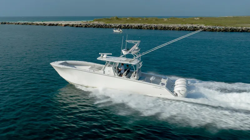 Slide: The Image of 2023 SeaHunter 46 CTS boat cruising on open water, showcasing sleek design and powerful engines. - 8