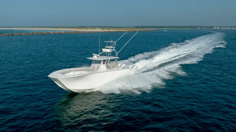 Slide: The Image of 2023 SeaHunter 46 CTS boat cruising swiftly on open water. - 9