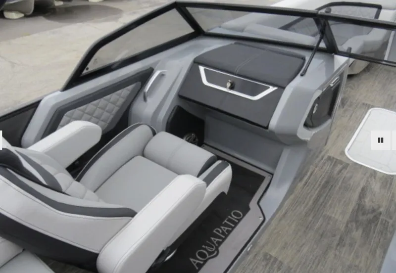 Slide: The Image of 2023 Godfrey AquaPatio 255 ULW interior with luxurious seating and modern dashboard. - 6