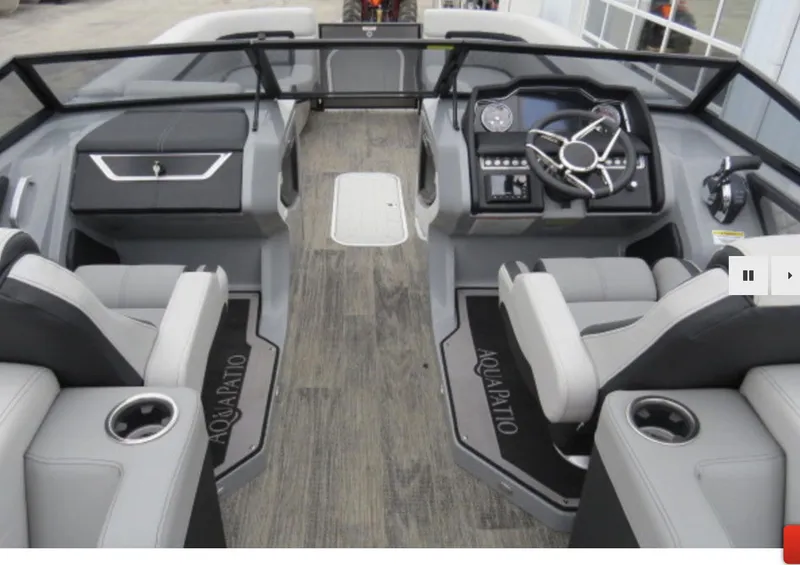 Slide: The Image of 2023 Godfrey AquaPatio 255 ULW boat interior with dual captain's chairs and modern dashboard. - 7