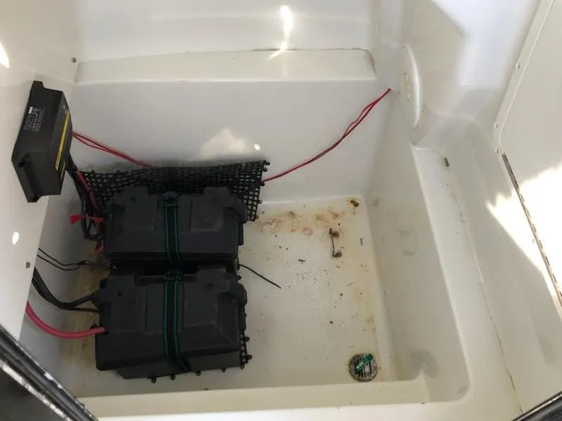 Slide: The Image of 2004 Triton 2690 CC battery compartment with dual batteries and wiring. - 2