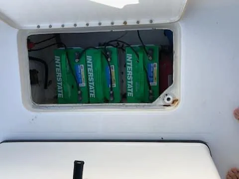 Slide: The Image of 2004 Triton 2690 CC boat battery compartment with Interstate batteries. - 3