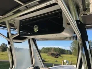 Slide: The Image of 2004 Triton 2690 CC boat interior with overhead storage compartment. - 6