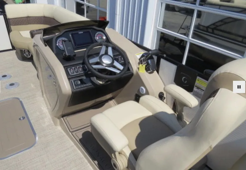 Slide: The Image of 2023 Godfrey Monaco 235 SFL boat interior with steering console and seating. - 5