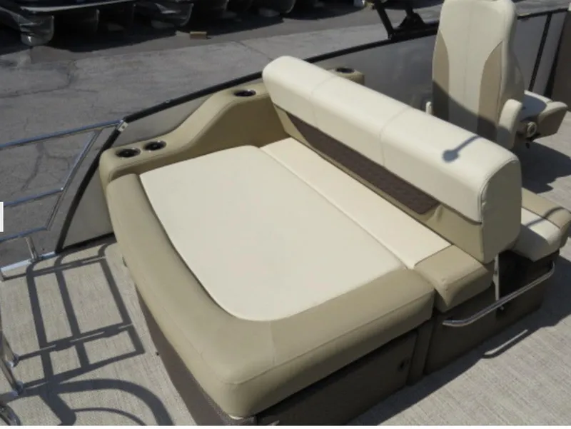 Slide: The Image of 2023 Godfrey Monaco 235 SFL boat with beige seating and cup holders. - 8