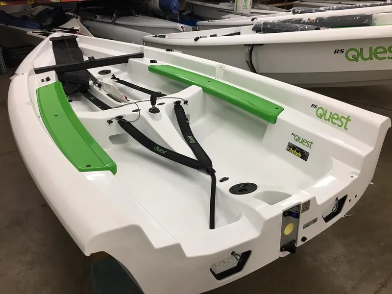 Slide: The Image of 2025 RS Quest sailboat with green accents, displayed indoors. - 3