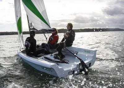 Slide: The Image of 2023 RS Quest sailboat with three people sailing on a lake. - 5