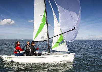 Slide: The Image of 2023 RS Quest sailboat with three people sailing on open water. - 6