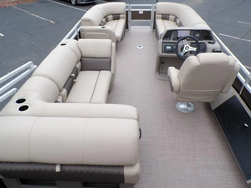 Slide: The Image of 2024 Sun Tracker SportFish™ 22 DLX pontoon boat interior with beige seating and helm. - 13