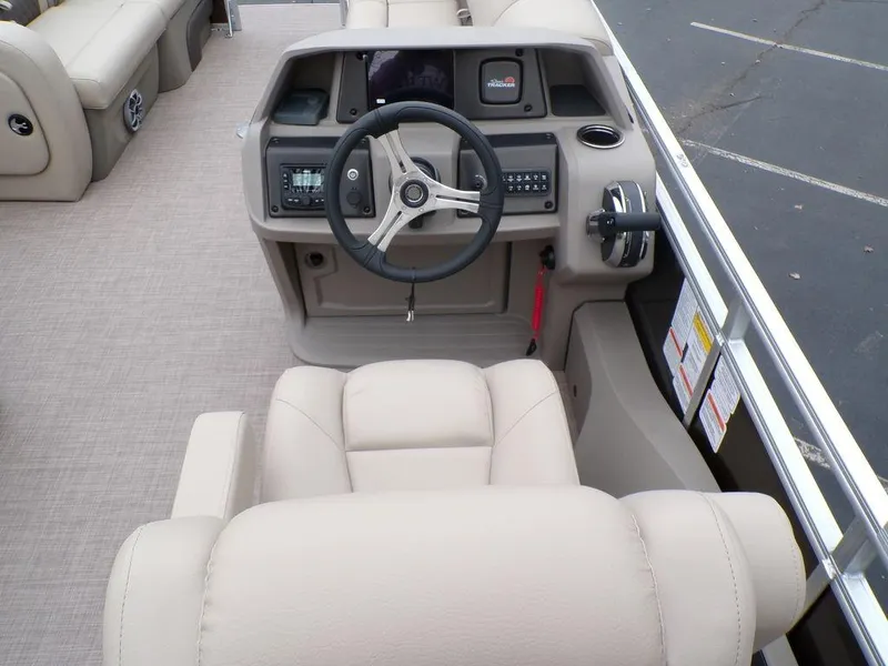 Slide: The Image of 2024 Sun Tracker SportFish™ 22 DLX boat helm with beige seating and modern controls. - 14