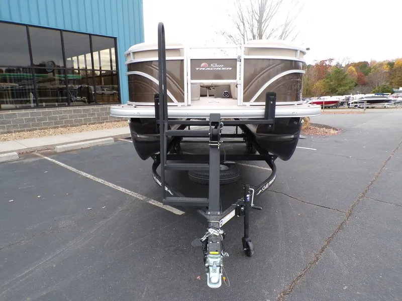 Slide: The Image of 2024 Sun Tracker SportFish™ 22 DLX pontoon boat on a trailer in a parking lot. - 8