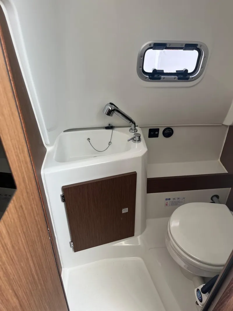 Slide: The Image of 2024 Jeanneau Leader 9.0 CC boat bathroom with sink and toilet. - 13