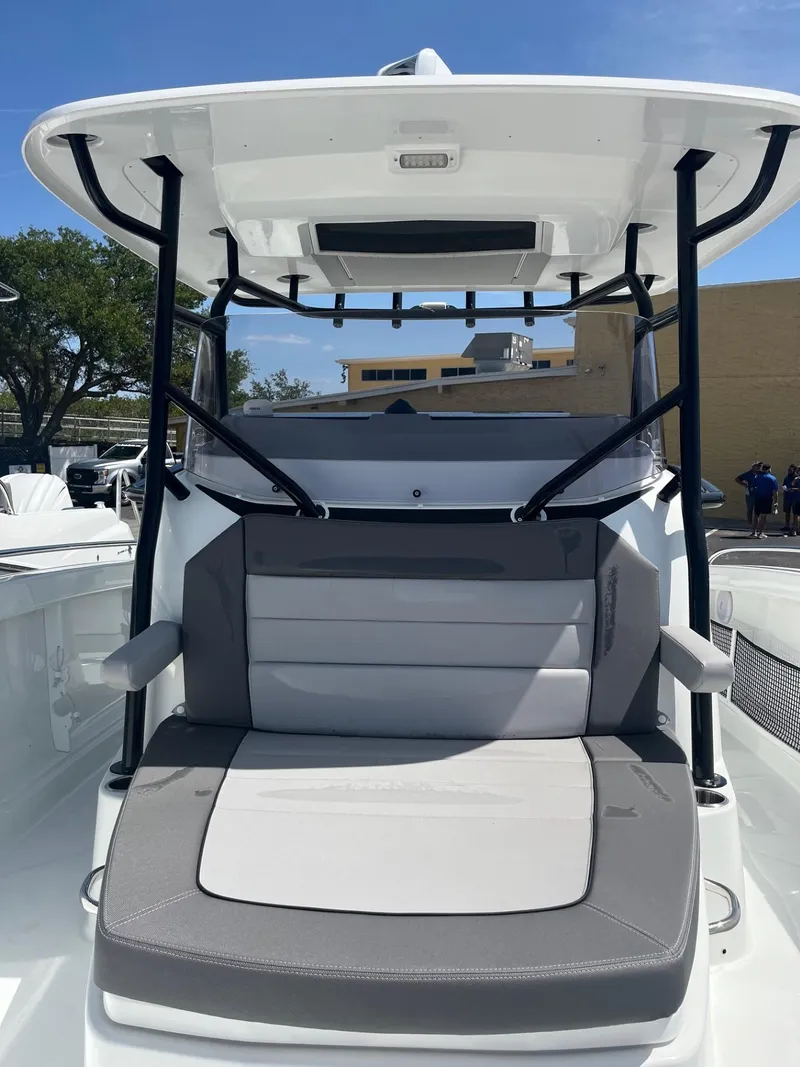 Slide: The Image of 2024 Jeanneau Leader 9.0 CC boat with cushioned seating and canopy. - 14