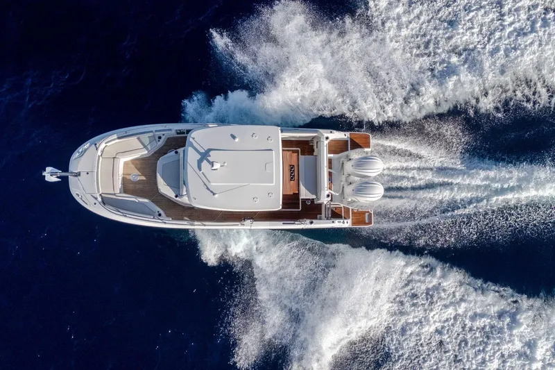 Slide: The Image of Aerial view of 2027 Jeanneau Leader 9.0 CC cruising on open water. - 13