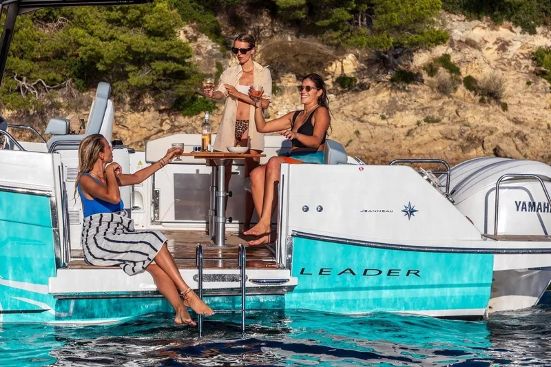 Slide: The Image of Women enjoying drinks on a 2027 Jeanneau Leader 9.0 CC boat. - 19