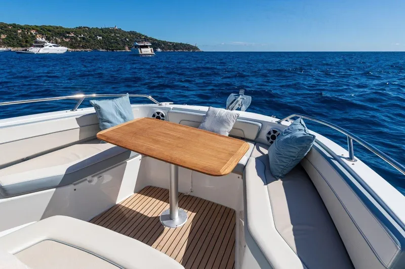 Slide: The Image of Luxurious Jeanneau Leader 9.0 CC boat interior with ocean view, featuring comfortable seating and table. - 8