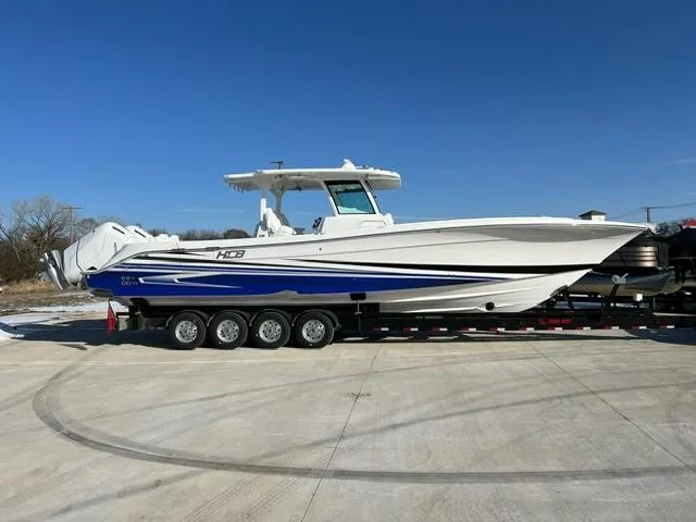Slide: The Image of 2023 HCB 39 Speciale boat on trailer, side view, white and blue. - 1