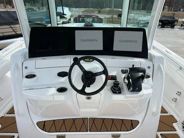 Slide: The Image of 2023 HCB 39 Speciale boat helm with Garmin navigation screens. - 10