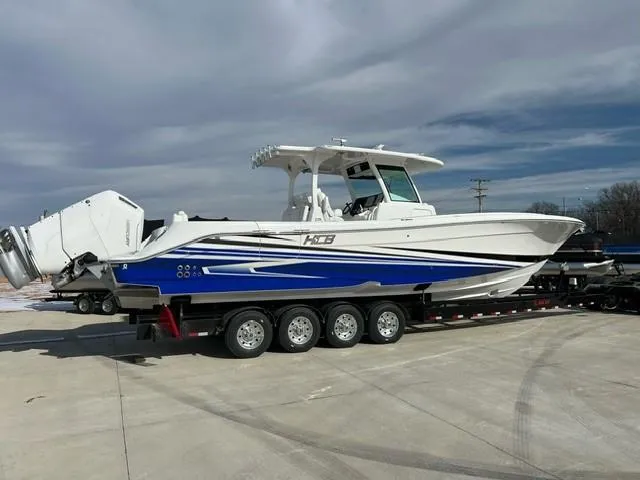 Slide: The Image of 2023 HCB 39 Speciale boat on a trailer, white and blue exterior. - 15